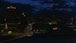5.7K aerial stock footage of a city street between high-rise hotel and auditorium at twilight during descent, Downtown Albuquerque, New Mexico Aerial Stock Footage | DX0002_128_049