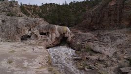 5.7K aerial stock footage of an orbit of river rapids flowing through a rock formation in the mountains in New Mexico Aerial Stock Footage | DX0002_129_003
