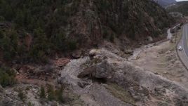 5.7K aerial stock footage ascend and fly away from river rapids flowing through a rock formation in the mountains in New Mexico Aerial Stock Footage | DX0002_129_005