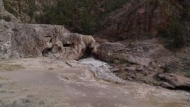 5.7K aerial stock footage descend for low view of river rapids flowing through a rock formation in the mountains in New Mexico Aerial Stock Footage | DX0002_129_008