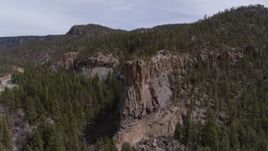 5.7K aerial stock footage of circling around the end of a rock formation jutting from a mountain in New Mexico Aerial Stock Footage | DX0002_129_013