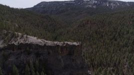 5.7K aerial stock footage descend by the end of a rock formation jutting from a mountain in New Mexico Aerial Stock Footage | DX0002_129_016