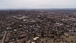 5.7K aerial stock footage reverse view of the downtown area and surrounding city of Santa Fe, New Mexico Aerial Stock Footage | DX0002_129_020