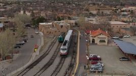 5.7K aerial stock footage an orbit of passenger train at the station in Santa Fe, New Mexico Aerial Stock Footage | DX0002_130_017