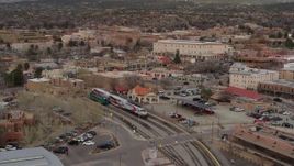 5.7K aerial stock footage circling a passenger train at a station in Santa Fe, New Mexico, tilt to top of the train Aerial Stock Footage | DX0002_130_020