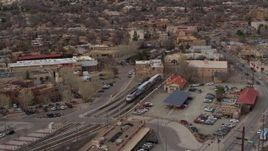 5.7K aerial stock footage fly around a passenger train at a station in Santa Fe, New Mexico, tilt to top of the train Aerial Stock Footage | DX0002_130_022