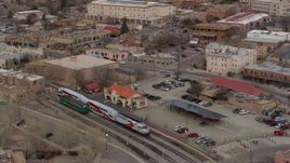 5.7K aerial stock footage approach and tilt to a passenger train at a station in Santa Fe, New Mexico, tilt to top of the train Aerial Stock Footage | DX0002_130_023