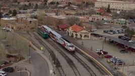 5.7K aerial stock footage descend near a passenger train at a station in Santa Fe, New Mexico Aerial Stock Footage | DX0002_130_024