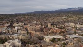 5.7K aerial stock footage fly away from and past downtown area of Santa Fe, New Mexico Aerial Stock Footage | DX0002_131_014