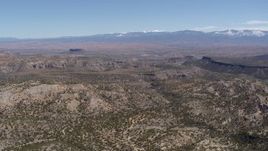 5.7K aerial stock footage reverse view of desert mesas and distant mountains in New Mexico Aerial Stock Footage | DX0002_133_013