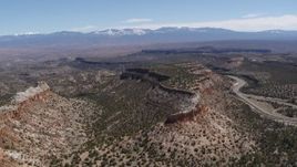 5.7K aerial stock footage of flying away from flat desert mesas and distant mountains in New Mexico Aerial Stock Footage | DX0002_133_016