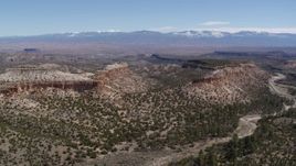 5.7K aerial stock footage of flying by flat desert mesas and distant mountains in New Mexico Aerial Stock Footage | DX0002_133_017