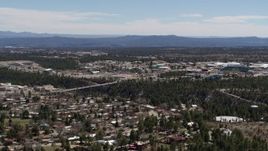 5.7K aerial stock footage reverse view of a bridge across a canyon and the Los Alamos National Laboratory, New Mexico Aerial Stock Footage | DX0002_134_002
