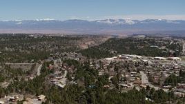 5.7K aerial stock footage distant mountains while flying by homes near mesas and canyons in Los Alamos, New Mexico Aerial Stock Footage | DX0002_134_010
