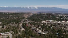5.7K aerial stock footage distant mountains while flying past homes near mesas and canyons in Los Alamos, New Mexico Aerial Stock Footage | DX0002_134_011