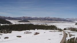 5.7K aerial stock footage of distant mountains seen across a snowy valley, New Mexico Aerial Stock Footage | DX0002_134_015