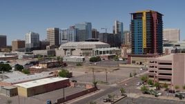 5.7K aerial stock footage of a slow approach to the arena past the condo complex in Downtown Phoenix, Arizona Aerial Stock Footage | DX0002_136_013