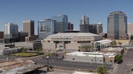 5.7K aerial stock footage of a slow reverse view from the arena near office buildings in Downtown Phoenix, Arizona Aerial Stock Footage | DX0002_136_014