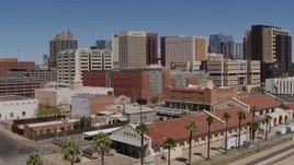 5.7K aerial stock footage of flying toward a train station and the city skyline of Downtown Phoenix, Arizona Aerial Stock Footage | DX0002_136_022