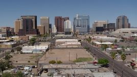 5.7K aerial stock footage of following a city street toward tall office buildings, Downtown Phoenix, Arizona Aerial Stock Footage | DX0002_136_025