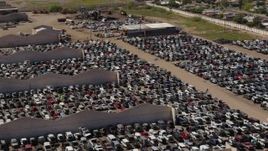 5.7K aerial stock footage of flying by cars at an automobile junkyard in Phoenix, Arizona Aerial Stock Footage | DX0002_136_042