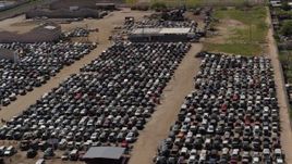 5.7K aerial stock footage of passing by rows of cars at an automobile junkyard in Phoenix, Arizona Aerial Stock Footage | DX0002_136_043