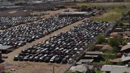 5.7K aerial stock footage of flying by urban homes and cars at a junkyard in Phoenix, Arizona Aerial Stock Footage | DX0002_136_045