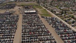 5.7K aerial stock footage of orbiting rows of cars at an automobile junkyard in Phoenix, Arizona Aerial Stock Footage | DX0002_137_002