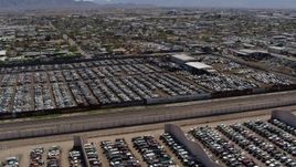 5.7K aerial stock footage orbit around rows of cars at an automobile junkyard in Phoenix, Arizona Aerial Stock Footage | DX0002_137_010