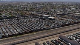 5.7K aerial stock footage a stationary view of rows of cars at an automobile junkyard in Phoenix, Arizona Aerial Stock Footage | DX0002_137_011