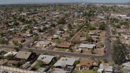 5.7K aerial stock footage of flying away from urban homes in Phoenix, Arizona Aerial Stock Footage | DX0002_137_014