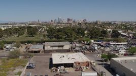 5.7K aerial stock footage of a wide view of the city's skyline from industrial buildings and cemetery in Downtown Phoenix, Arizona Aerial Stock Footage | DX0002_137_018