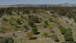 5.7K aerial stock footage orbiting gravestones and green lawn at a cemetery in Phoenix, Arizona Aerial Stock Footage | DX0002_137_025
