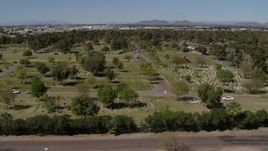 5.7K aerial stock footage flyby green lawn and gravestones at a cemetery in Phoenix, Arizona Aerial Stock Footage | DX0002_137_027