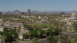 5.7K aerial stock footage distant BMO Tower seen while passing by University Park in Phoenix, Arizona Aerial Stock Footage | DX0002_137_046