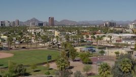 5.7K aerial stock footage a view of BMO Tower seen while passing University Park in Phoenix, Arizona Aerial Stock Footage | DX0002_137_047