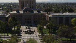 5.7K aerial stock footage approach flags in front of the Arizona State Capitol building in Phoenix, Arizona Aerial Stock Footage | DX0002_137_067
