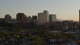 5.7K aerial stock footage of a hotel flanked by high-rise office buildings at sunset in Downtown Phoenix, Arizona Aerial Stock Footage | DX0002_138_046
