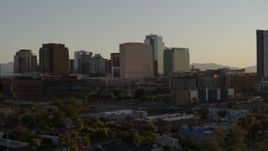 5.7K aerial stock footage of reverse view of a hotel and high-rise office buildings at sunset in Downtown Phoenix, Arizona Aerial Stock Footage | DX0002_138_048