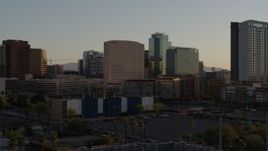 5.7K aerial stock footage of flying away from hotel and tall office buildings at sunset in Downtown Phoenix, Arizona Aerial Stock Footage | DX0002_138_050