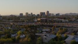 5.7K aerial stock footage of towering office buildings in the distance at sunset in Phoenix, Arizona Aerial Stock Footage | DX0002_138_053