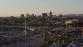 5.7K aerial stock footage of towering office buildings in the distance at sunset in Phoenix, Arizona Aerial Stock Footage | DX0002_138_054