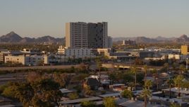 5.7K aerial stock footage of reverse view of a hospital complex at sunset in Phoenix, Arizona Aerial Stock Footage | DX0002_138_057