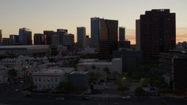 5.7K aerial stock footage of flying by office high-rises, reveal college building at sunset in Downtown Phoenix, Arizona Aerial Stock Footage | DX0002_139_001