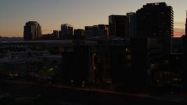 5.7K aerial stock footage of flyby and away from tall office high-rises at sunset in Downtown Phoenix, Arizona Aerial Stock Footage | DX0002_139_012