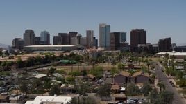 5.7K aerial stock footage of flying by the city's skyline, seen from homes in Downtown Phoenix, Arizona Aerial Stock Footage | DX0002_140_010