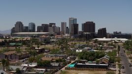 5.7K aerial stock footage of passing by the city's skyline, seen from homes in Downtown Phoenix, Arizona Aerial Stock Footage | DX0002_140_011