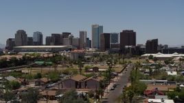 5.7K aerial stock footage of flying by and away from the city's skyline, seen from homes in Downtown Phoenix, Arizona Aerial Stock Footage | DX0002_140_012