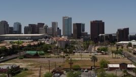 5.7K aerial stock footage flying by park while focused on the city's skyline, Downtown Phoenix, Arizona Aerial Stock Footage | DX0002_140_015