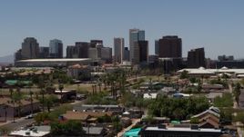 5.7K aerial stock footage passing by park and homes while focused on the city's skyline, Downtown Phoenix, Arizona Aerial Stock Footage | DX0002_140_016